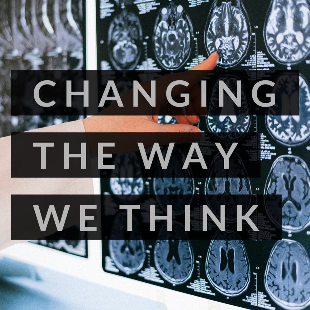 a poster saying CHANGING THE WAY WE THINK with X-rays in the background