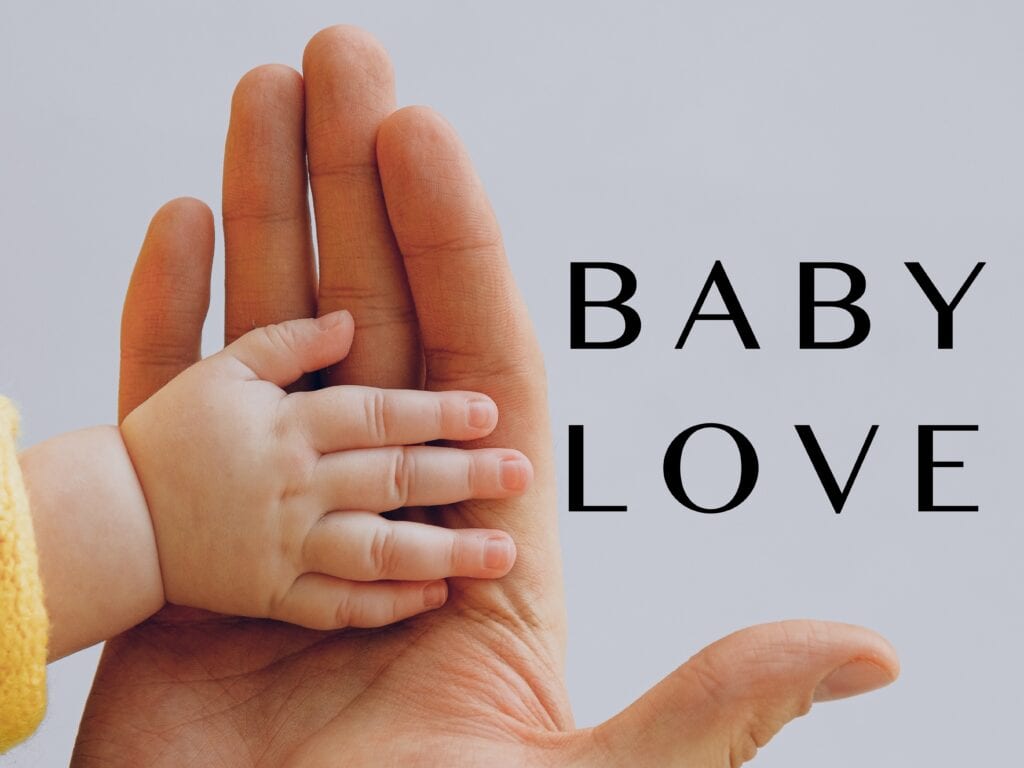 a poster saying BABY LOVE with baby hands in the background