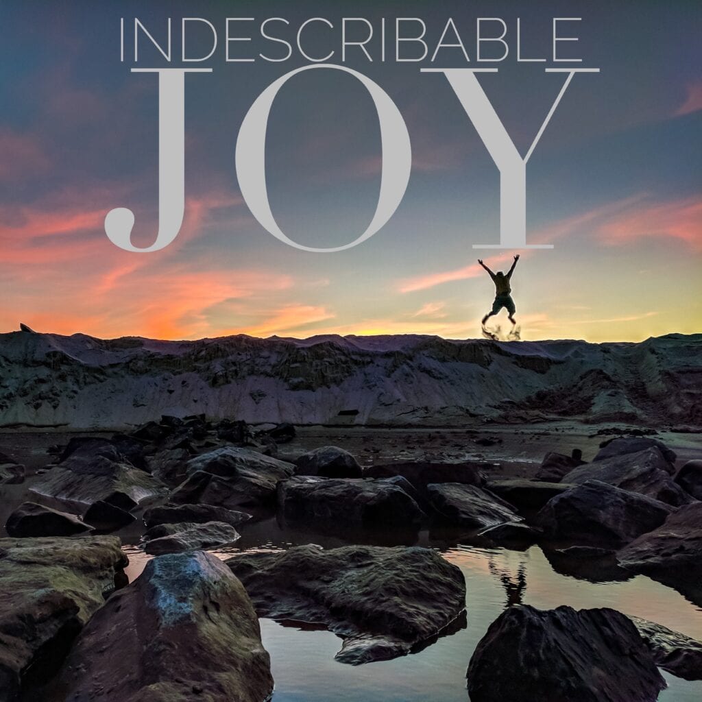 a photo of a person jumping off sand in joy