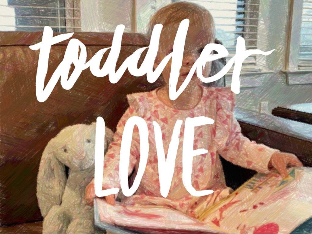 a poster saying toddler LOVE with a toddler in the background